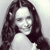 Pixelated grayscale image of a person with long dark hair, closed eyes, and a neutral expression against a light background.