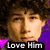 Pixelated image of a person with brown hair and light skin, wearing a purple garment, with text "Love Him" at the bottom.