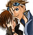 Two pixelated figures in close physical proximity, one with brown hair and a blue cap, the other with brown hair and a dark jacket, both facing left.