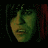 A pixelated image of a person with dark hair and greenish skin tone, showing three sequential facial expressions against a dark background with red vertical elements.