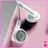 A hand holds white over-ear headphones against a pink background with two small red squares below.