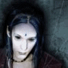 identical figures with pale skin, dark hair, and a bindi-like mark on the forehead, wearing a dark red garment against a textured gray background