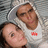 Two people in a close-up pose with one person wearing a white shirt featuring a red heart symbol on the chest.