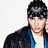 Pixelated image of a person with dark hair wearing a black jacket over a white shirt and blue inner layer, shown in three views with slight head position changes.