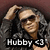 Pixelated image of a person with long dark hair wearing sunglasses and a black shirt, with text reading 'Hubby <3' at the bottom.