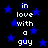 Black background with blue stars and white text reading "in love with a guy" repeated in two