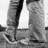 Black-and-white pixelated image showing two figures in formal attire standing side-by-side with a bright rectangular shape between them.