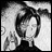 Black-and-white pixelated image of a character with dark hair and a white face, next to text reading "Anime IM" and "COM" on a black background.