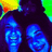 Two smiling people with dark hair appear in a blue-toned section, next to green background with 'friens' text and below a blue area with '<33' symbol.