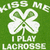 Green background with white four-leaf clover symbols and text reading "KISS ME I PLAY LACROSSE" in pixelated font.
