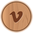 Circular wooden icon with a brown 'V' symbol centered on a light brown wood grain background, bordered by a darker brown ring.