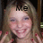 Pixelated image of a smiling person with light brown hair, wearing dark clothing and holding a microphone, with 'Me' text overlaid on the forehead.