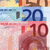 Pixelated image showing three distinct sections with numbers '20' and '10' in blue and red, respectively, against light blue and pink backgrounds.