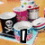 Animated sequence showing a cupcake tray, a hand with blue nails, and a striped roof with text overlays.