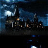 Animated nighttime view of a large, dark castle with illuminated windows under a cloudy sky featuring a bright moon.