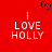Red background with white text reading "I LOVE HOLLY" and a black pixelated heart symbol above the text.