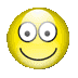Four circular pixelated icons with glossy surfaces arranged in a , each featuring large white eyes with gray pupils and black curved smiles on yellow, red, purple, and green backgrounds