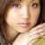 Pixelated close-up of a person with light skin tone, brown hair, and neutral expression wearing white clothing.