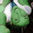 Green cartoon character with closed eyes and a smile, wearing white headgear against dark background with green text "surfer ashl3y97".