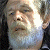 A pixelated contact sheet showing a partial face on the left and green text reading "Original Icons .com" on the right against a dark background.