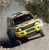 A yellow vehicle with dark blue accents appears in motion against a blurred background, rendered in low-resolution pixel art style.