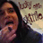 A pixelated image shows a person with dark hair and an open mouth on the left, next to a white background with black text symbols.