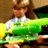 A pixelated image shows a person holding a large green and yellow object with text, below which the word 'gangsta' appears in bold black letters on white.