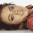 A woman in a red top and blue jeans lies on her back with knees bent, head turned left to right