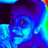 Pixelated face with blue and purple tones, featuring a visible eye and mouth area against dark background.
