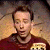 Animated contact sheet showing two frames of a pixelated character with brown hair and maroon shirt on left, next to green background with "Original Icons .com" text in bright green pixel font.
