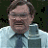 A 48x48 pixel animated contact sheet showing two frames of a buddy icon featuring a man in a light blue shirt and dark tie on the left, with green text "Original Icons .com" on a dark background to the right.