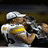 A pixelated animated sequence shows a person in white sports gear kissing another figure, with background figures visible.