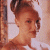 A pixelated image of a person with hair in an updo, wearing white clothing against a light background on the left side; green text reading 'Original Icons .com' appears on a dark green background on the right.