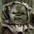Pixelated static image of a character with large ears and facial features in muted tones, likely from an animated film or series.