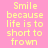 Yellow pixelated text on pink background reads "Smile because life is too short to frown" in two identical vertical
