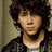 six showing a person with curly hair in various poses, some with red heart overlays and text reading "Nick Jonas Love"