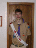Five static images of people in various settings, including scout uniforms, red polo shirts with yellow emblems, and a graduation gown.