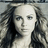 A pixelated grayscale portrait of a woman with long hair on the left, next to a red background with black pixelated text reading "SuperGirl is so DAMN HOTTT!!!".