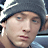 Pixelated image of a person wearing a gray beanie and dark clothing, with text 'EMINEM' above and '8 Mile' below on black background.