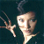 Pixelated image of a person with light skin and dark hair extending their right hand forward against a dark background.
