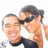 Two pixelated figures in close proximity, one with short dark hair wearing a dark top, the other with longer dark hair and a white top, both smiling with closed eyes.