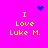 A bright pink background displays yellow text reading "I Love Luke M." with blue pixelated symbols above and below the text.