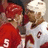 Two pixelated figures in sports uniforms with red and white colors, one wearing a red jersey with number 5 and the other in a white jersey with number 15, positioned closely together.