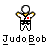 Pixelated figure in white and black martial arts uniform with yellow accents, arms raised, red square on chest, standing above stylized text.