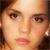 Pixelated close-up of a person's face showing eyes, nose, mouth, and part of the forehead with brown hair visible on the left side.