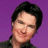 A 48x48 pixel animated contact sheet showing two frames: a person with dark hair against purple background on left, and red box with "ARRESTED DEVELOPMENT" text above it on right.