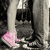A person wearing gray pants and pink shoes stands on a dark textured surface with a pink 'love' text overlay.
