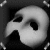 A grayscale animated icon featuring a stylized mask on the left and pixelated text 'DZAMA' on the right against a dark background with scattered light dots.