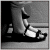 Black-and-white pixelated image of a person in white clothing reclining on a dark surface with one arm raised, set against a gradient background.