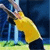 Pixelated static image of a yellow running figure with blue background elements and green ground, likely representing a sports-themed buddy icon.